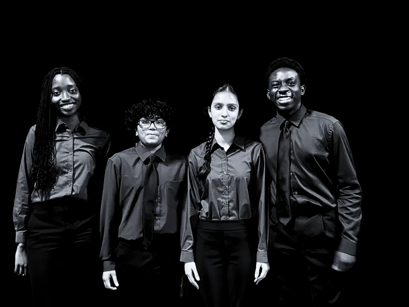 Four SharkMakers finalists in shirts and ties, photographed together against a black backdrop.