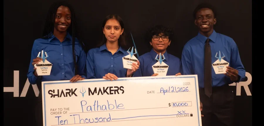 The four students of Pathable holding their first-place trophies and an oversized ten thousand dollar check.